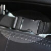 1960809883821.jpg Close-up of a car seat belt buckle and strap mounted to a padded car seat.