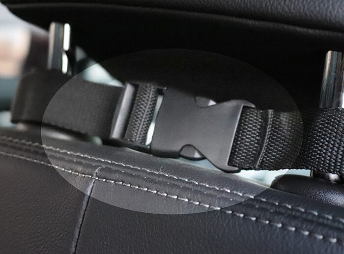 1960809883821.jpg Close-up of a car seat belt buckle and strap mounted to a padded car seat.