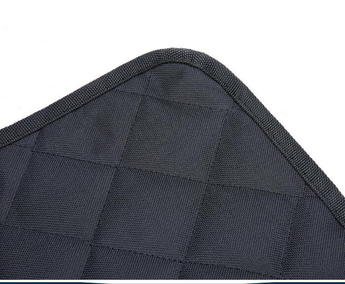 225553051240.jpg Close-up of dark quilted fabric with a square checkerboard pattern and binding along the edge