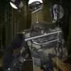 Camouflage tactical bag with multiple pockets and padded shoulder strap for outdoor use, shown in a forest setting.