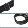 Close-up of a black adjustable nylon strap with a plastic buckle and part of a camouflage tactical harness.