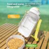 f431940f-1290-49f8-9365-d5631c29fde5_trans.jpeg Outdoor pet feeding and water station with a clear bottle and a bowl of dry food on a wooden table; includes 'Drinking water 1000ml' and 'Feeding 300ml' labels.
